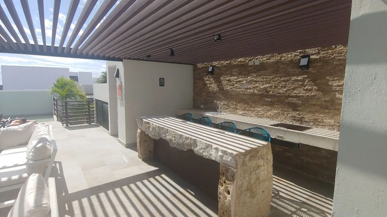 Covered rooftop terrace with a stone counter and sink