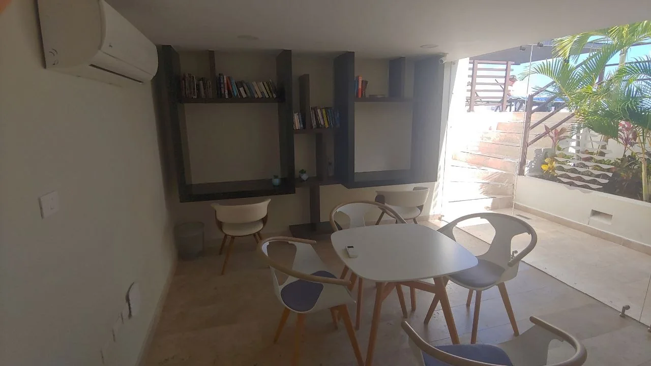 Shared workspace with round tables, chairs and bookshelves